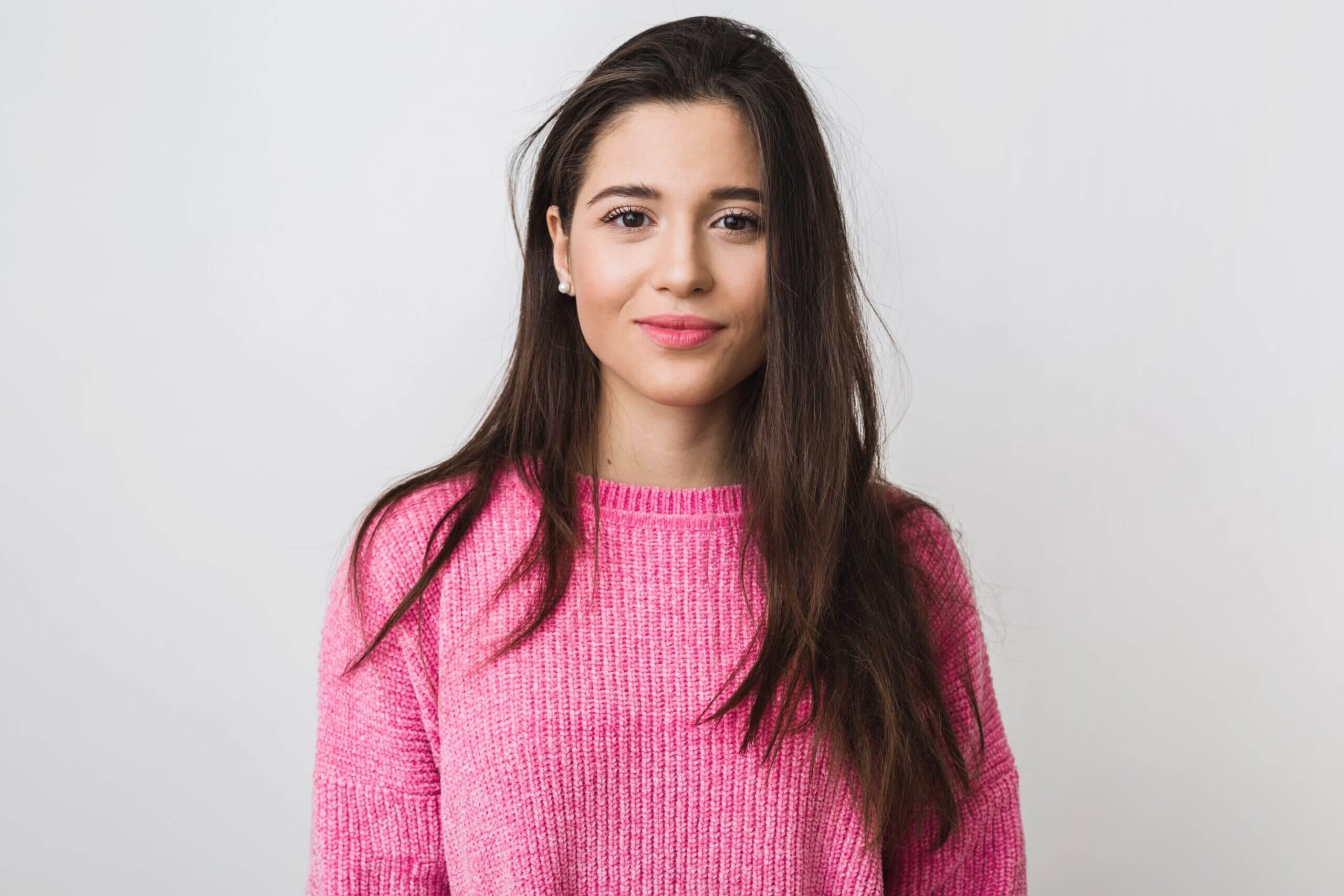 young-beautiful-woman-pink-warm-sweater-natural-look-smiling-portrait-isolated-long-hair-min-scaled